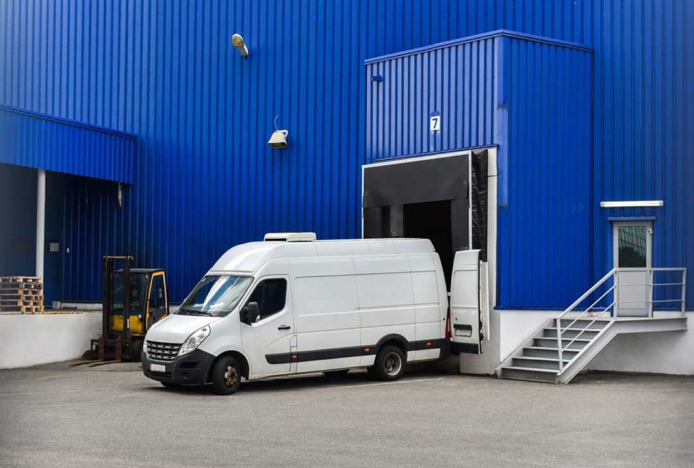 A van docked at a distribution centre loading bay