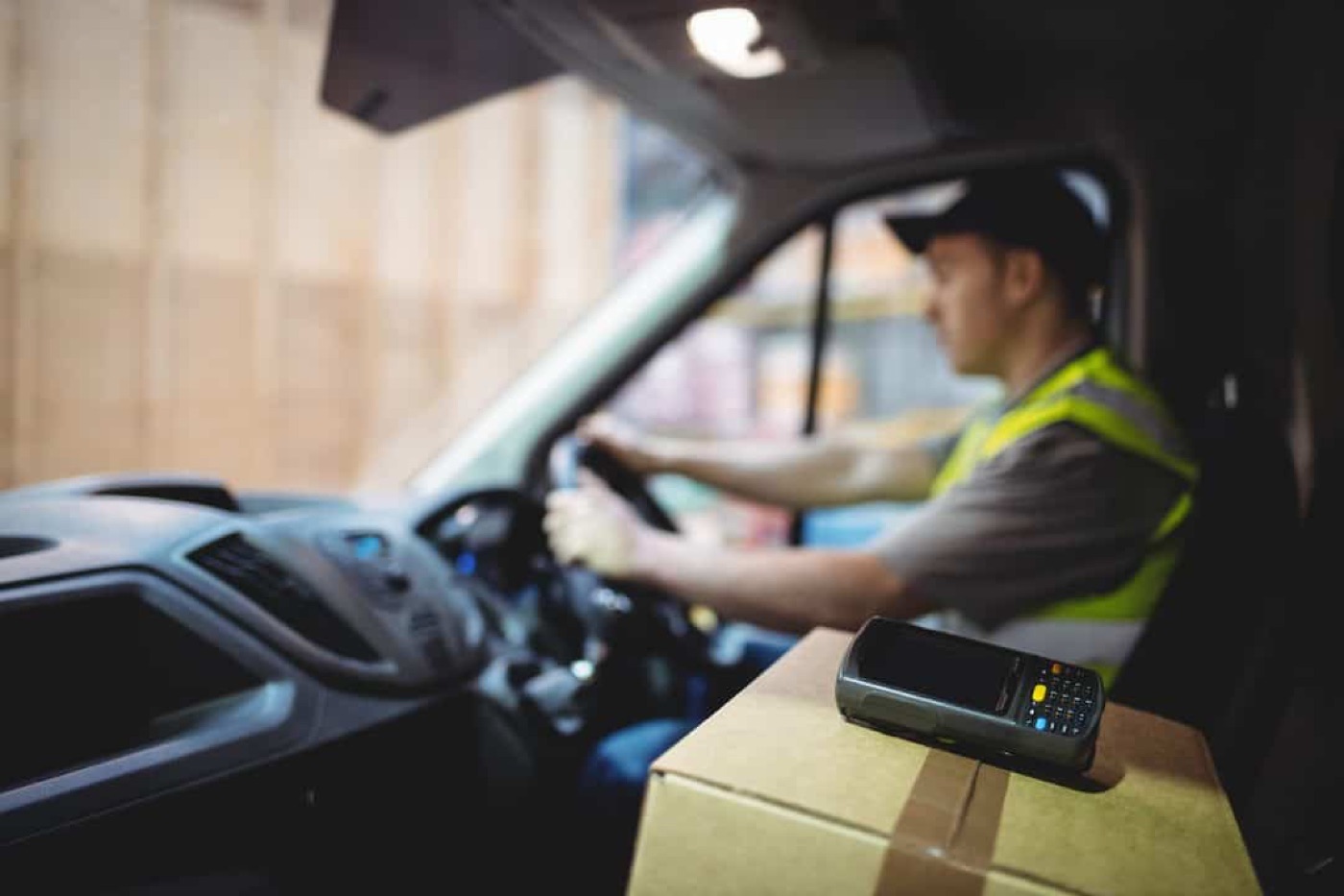 A driver using a handheld terminal in the cab