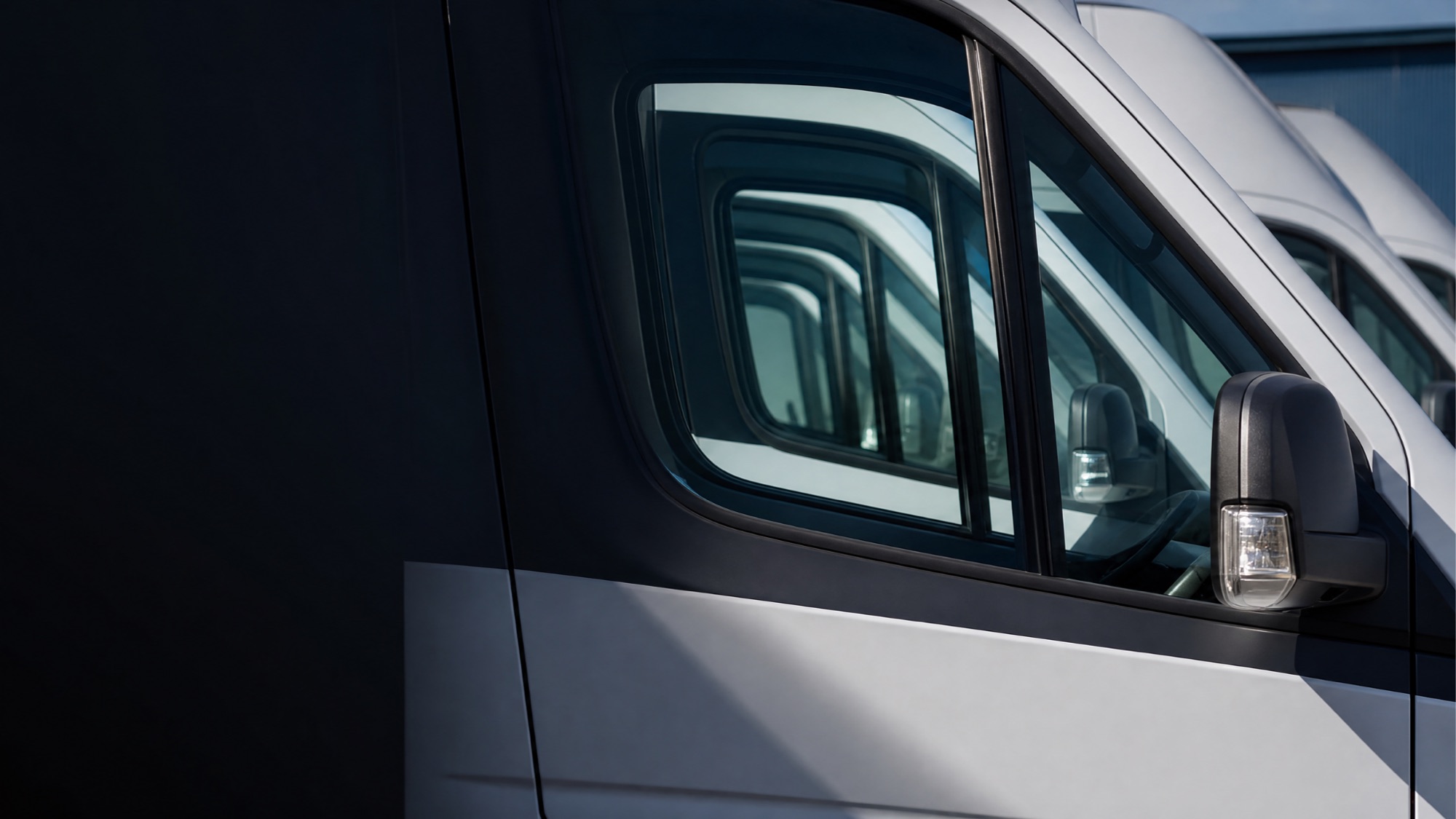 The Jump Up fleet parked side by side, cab windows reflecting in sequence